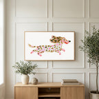 Running dachshund art on a TV above a light oak sideboard with olive branches in a bright living room