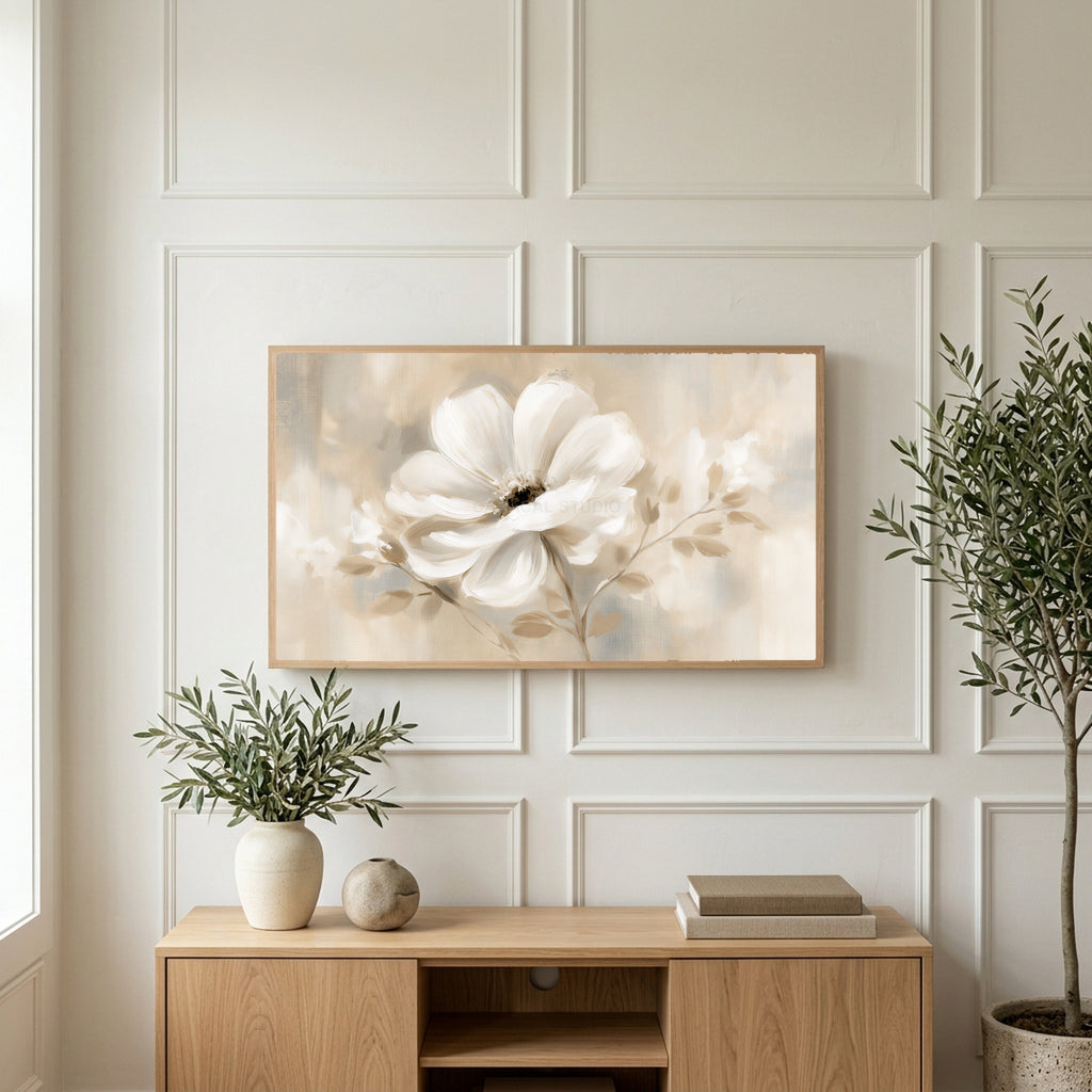 White flower art on a TV above a light oak sideboard with olive branches in a bright living room