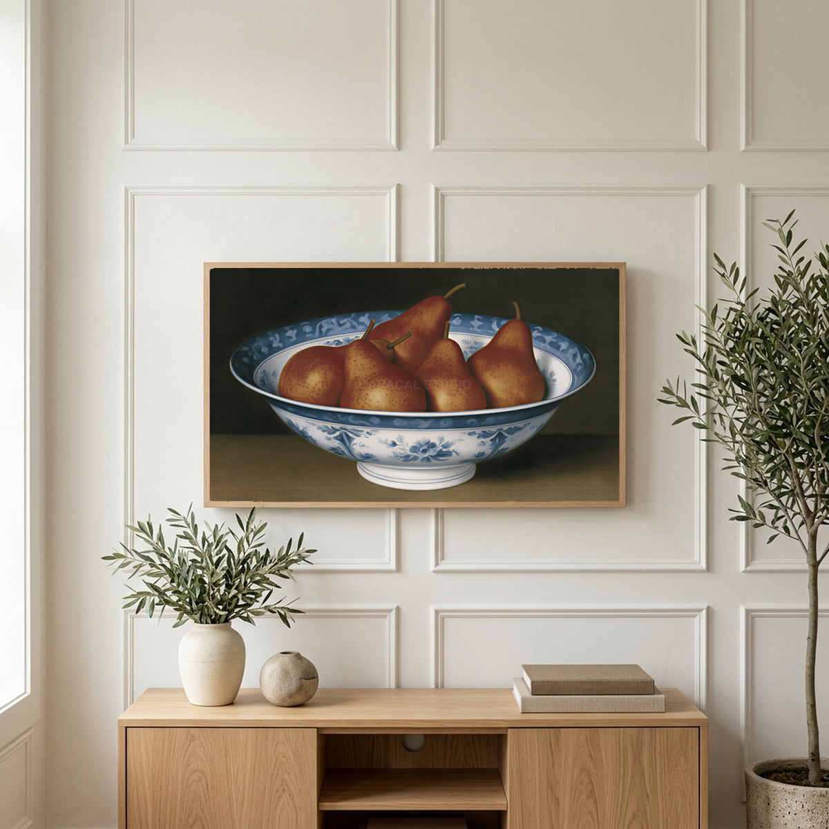 Pears in a porcelain bowl art on a TV above a light oak sideboard with olive branches in a bright living room