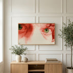 Red pencil eyes art on a TV above a light oak sideboard with olive branches in a bright living room