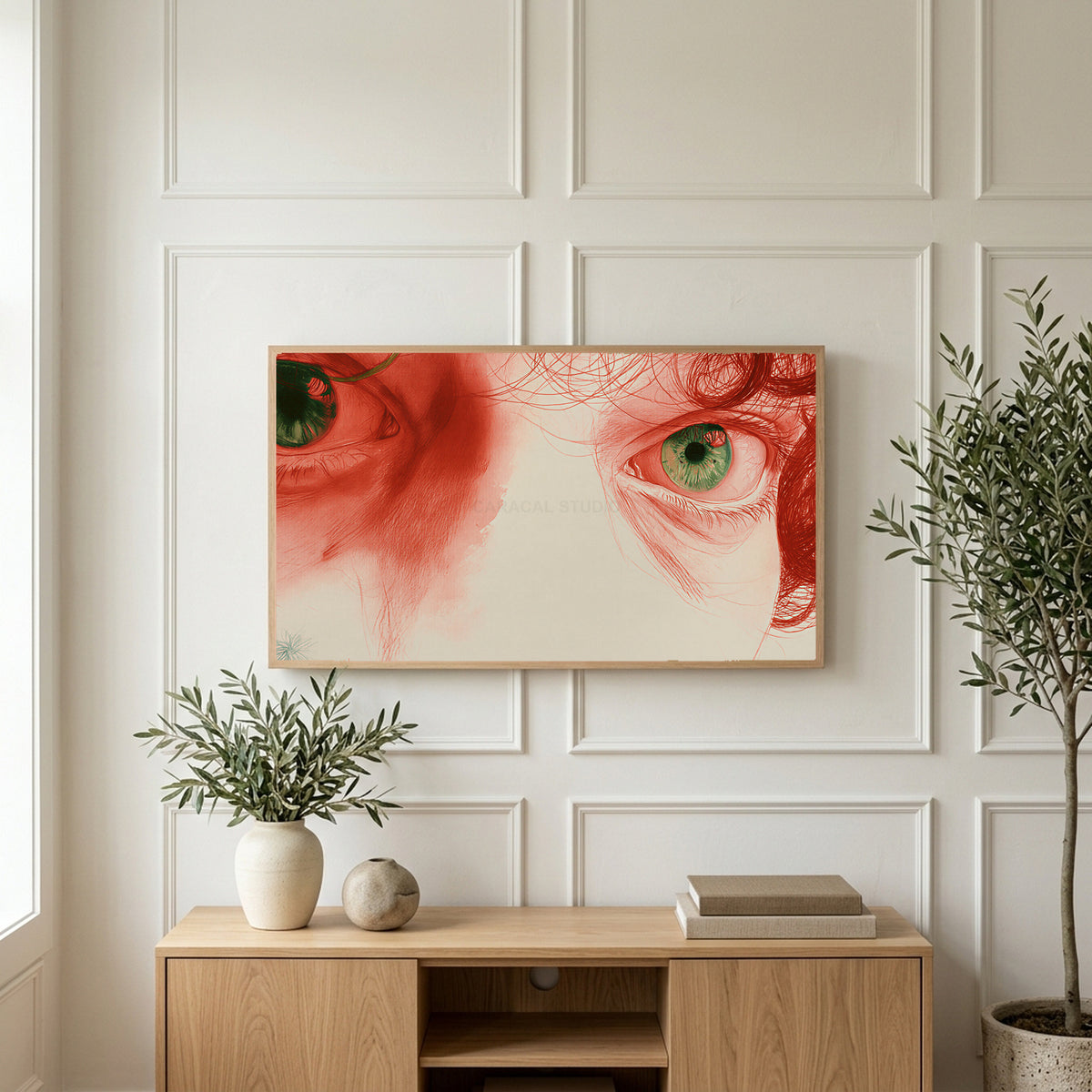 Red pencil eyes art on a TV above a light oak sideboard with olive branches in a bright living room