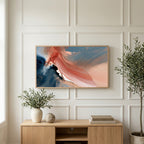 Coral and navy abstract art on a TV above a light oak sideboard with olive branches in a bright living room