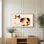 Calico cat art on a TV above a light oak sideboard with olive branches in a bright living room