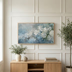 Hydrangea art on a TV above a light oak sideboard with olive branches in a bright living room