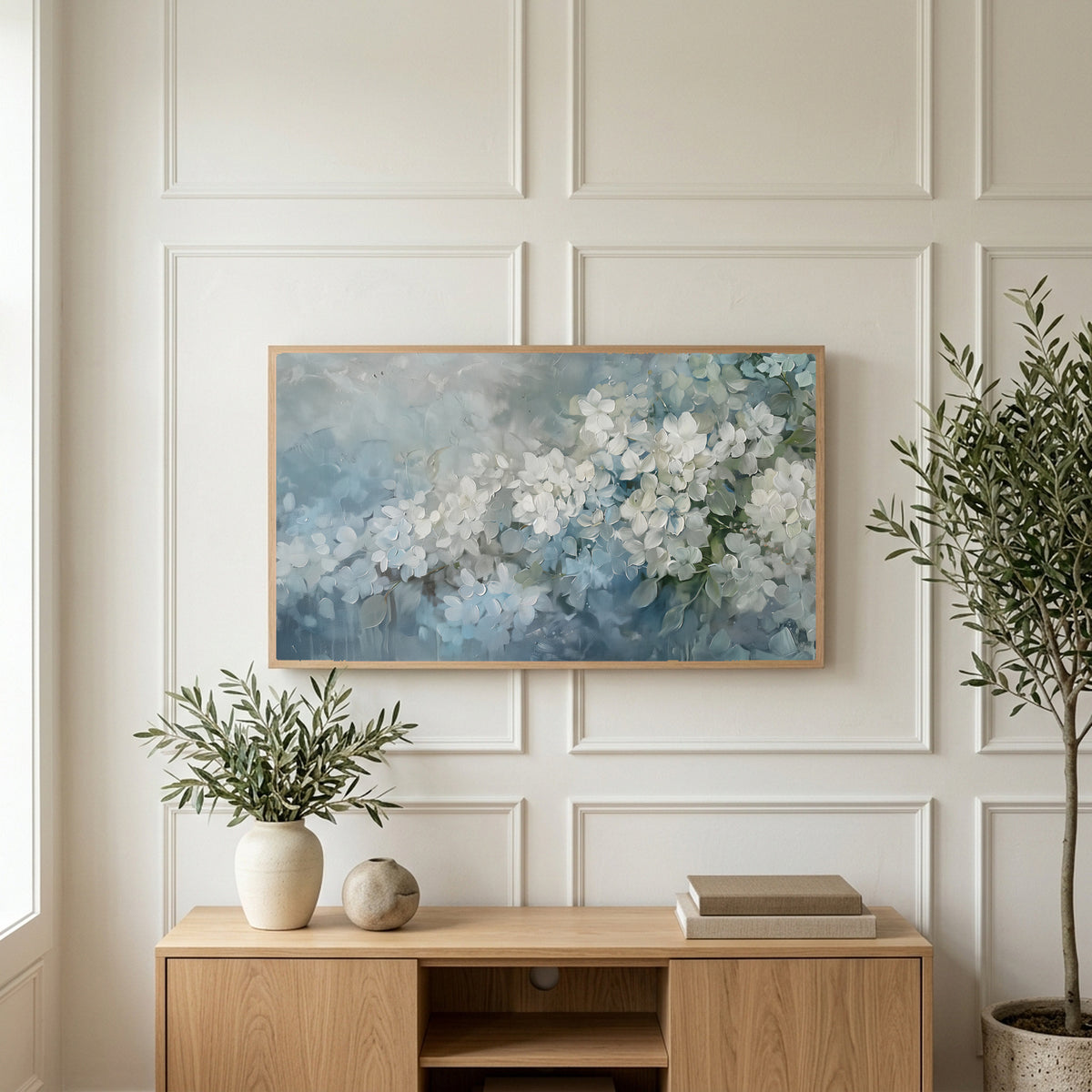 Hydrangea art on a TV above a light oak sideboard with olive branches in a bright living room