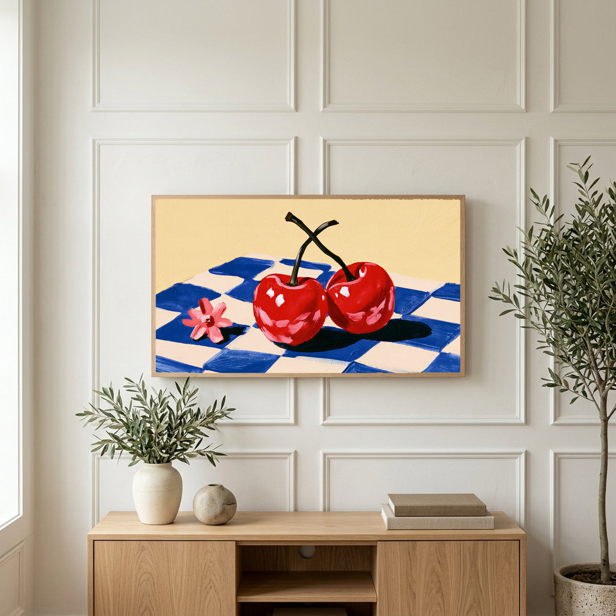 Cherry still life art on a TV above a light oak sideboard with olive branches in a bright living room