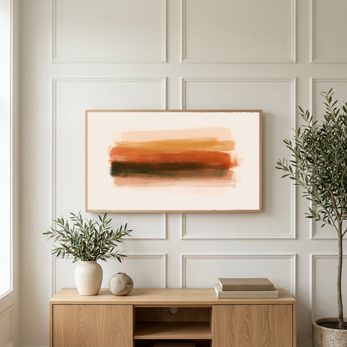 Terracotta brushstroke art on a TV above a light oak sideboard with olive branches in a bright living room