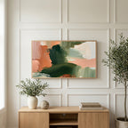 Green and peach abstract art on a TV above a light oak sideboard with olive branches in a bright living room