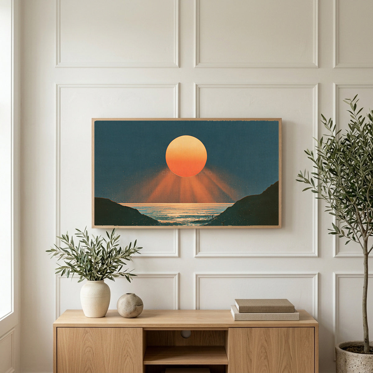 Ocean sunset art on a TV above a light oak sideboard with olive branches in a bright living room
