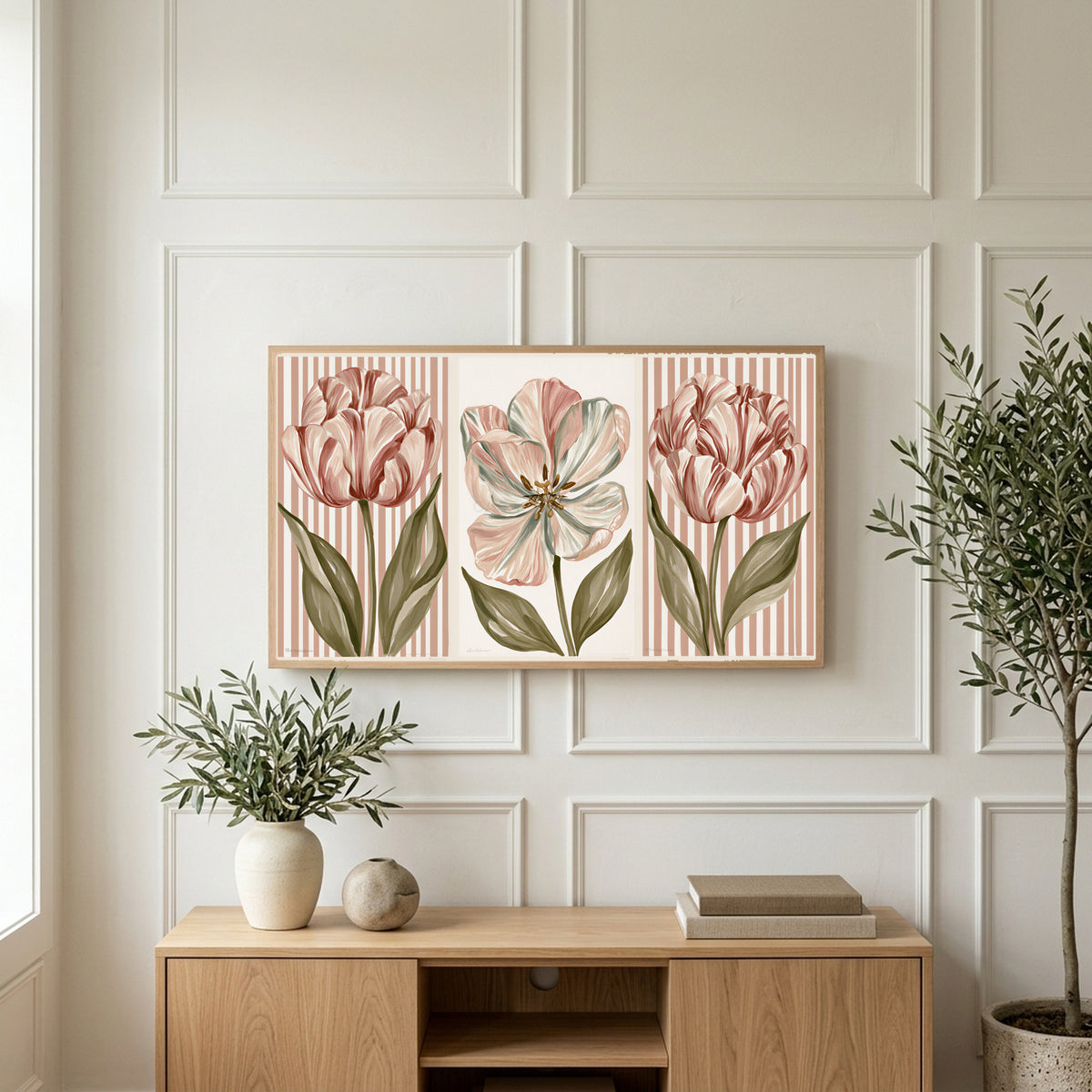 Tulip trio art on a TV above a light oak sideboard with olive branches in a bright living room