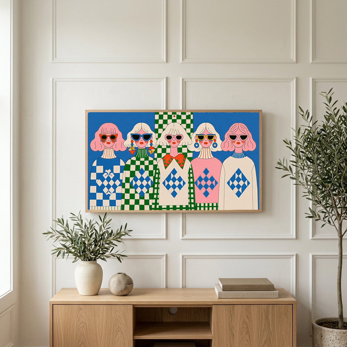 Retro women in sunglasses art on a TV above a light oak sideboard with olive branches in a bright living room
