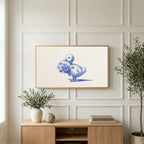 Duckling art on a TV above a light oak sideboard with olive branches in a bright living room