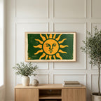 Woodblock sun art on a TV above a light oak sideboard with olive branches in a bright living room