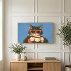 Coffee cat in sunglasses art on a TV above a light oak sideboard with olive branches in a bright living room