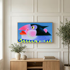 Pop art penguin art on a TV above a light oak sideboard with olive branches in a bright living room