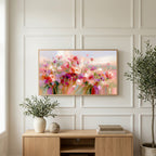 Pink wildflower meadow art on a TV above a light oak sideboard with olive branches in a bright living room