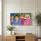 Cat ladies art on a TV above a light oak sideboard with olive branches in a bright living room