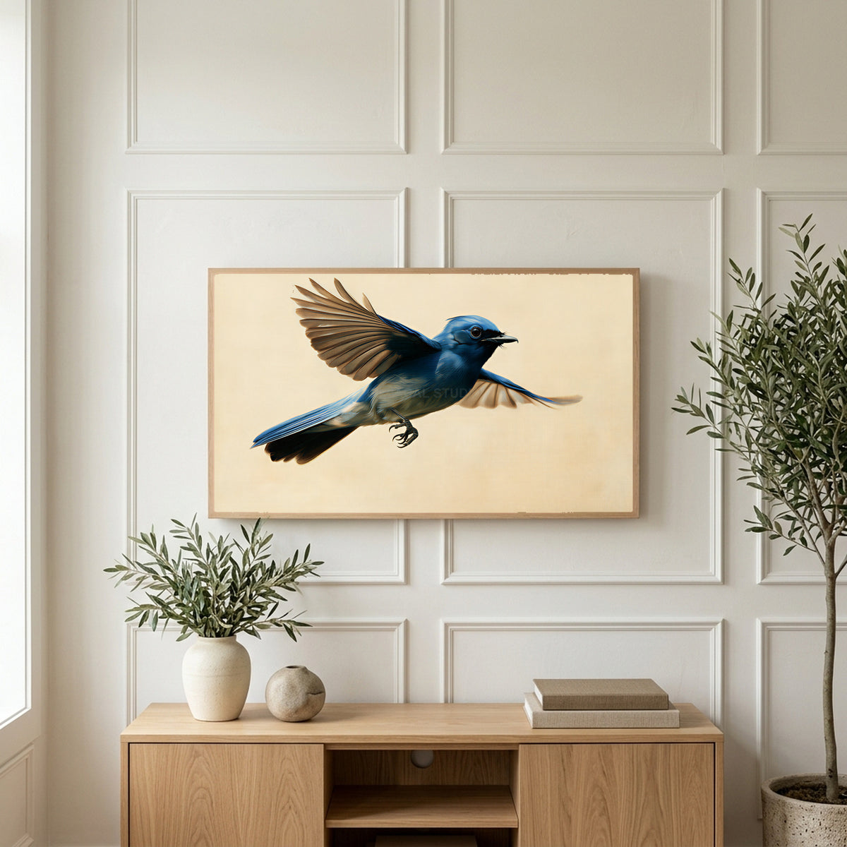 Blue flycatcher art on a TV above a light oak sideboard with olive branches in a bright living room