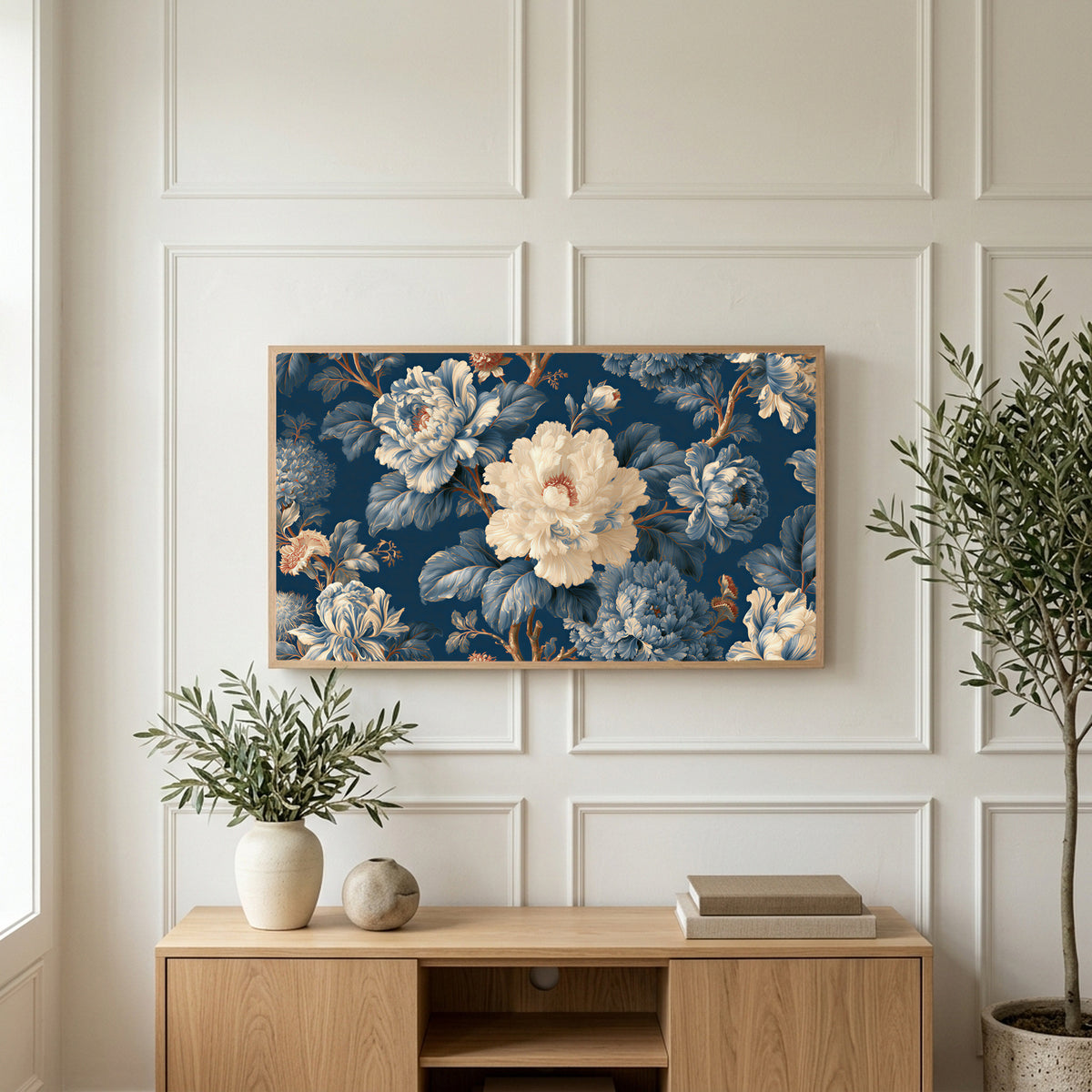 Blue and cream peonies art on a TV above a light oak sideboard with olive branches in a bright living room