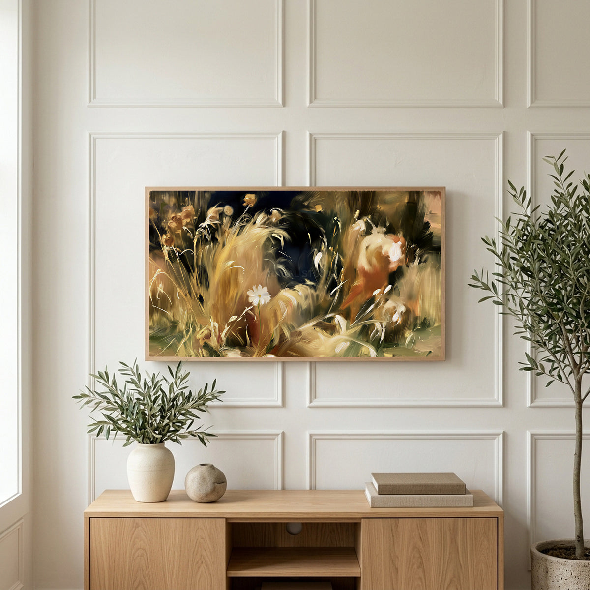 Wild grass and white flower art on a TV above a light oak sideboard with olive branches in a bright living room