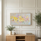 Pastel flower art on a TV above a light oak sideboard with olive branches in a bright living room