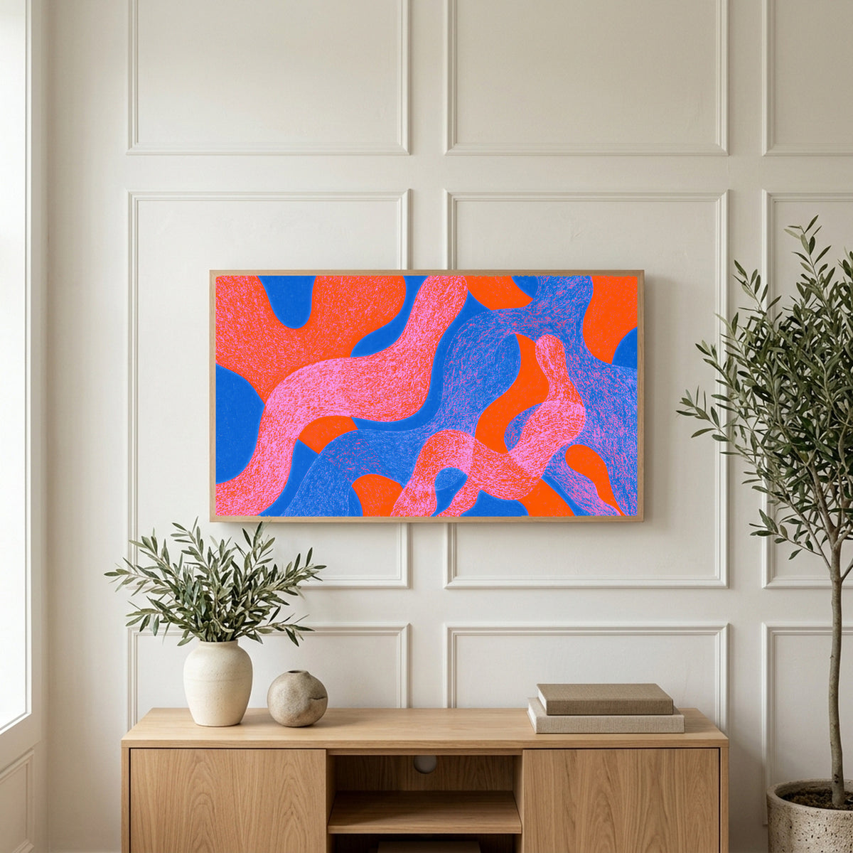Wavy abstract shapes art on a TV above a light oak sideboard with olive branches in a bright living room