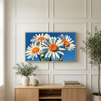 Daisy art on a TV above a light oak sideboard with olive branches in a bright living room