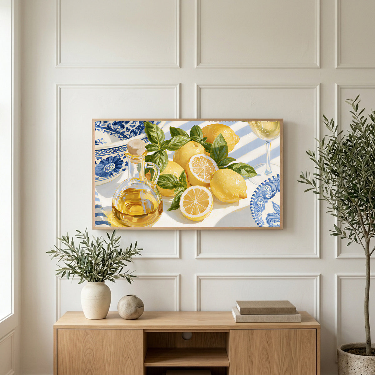 Lemons and olive oil art on a TV above a light oak sideboard with olive branches in a bright living room