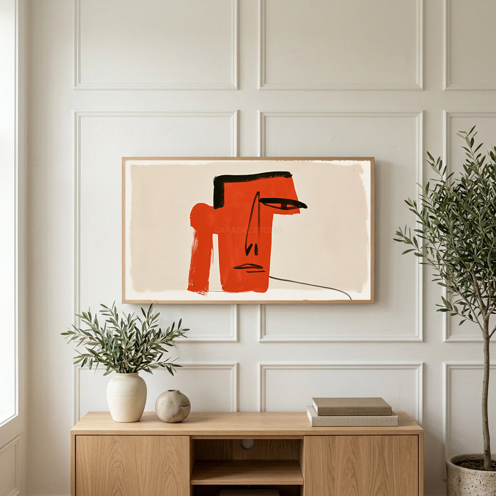 Red block face art on a TV above a light oak sideboard with olive branches in a bright living room
