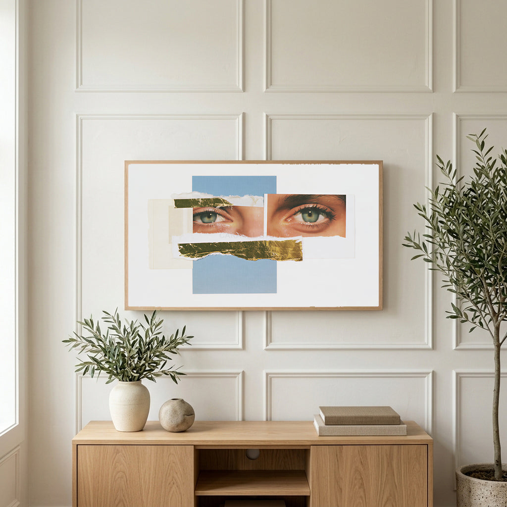 Eye collage art on a TV above a light oak sideboard with olive branches in a bright living room
