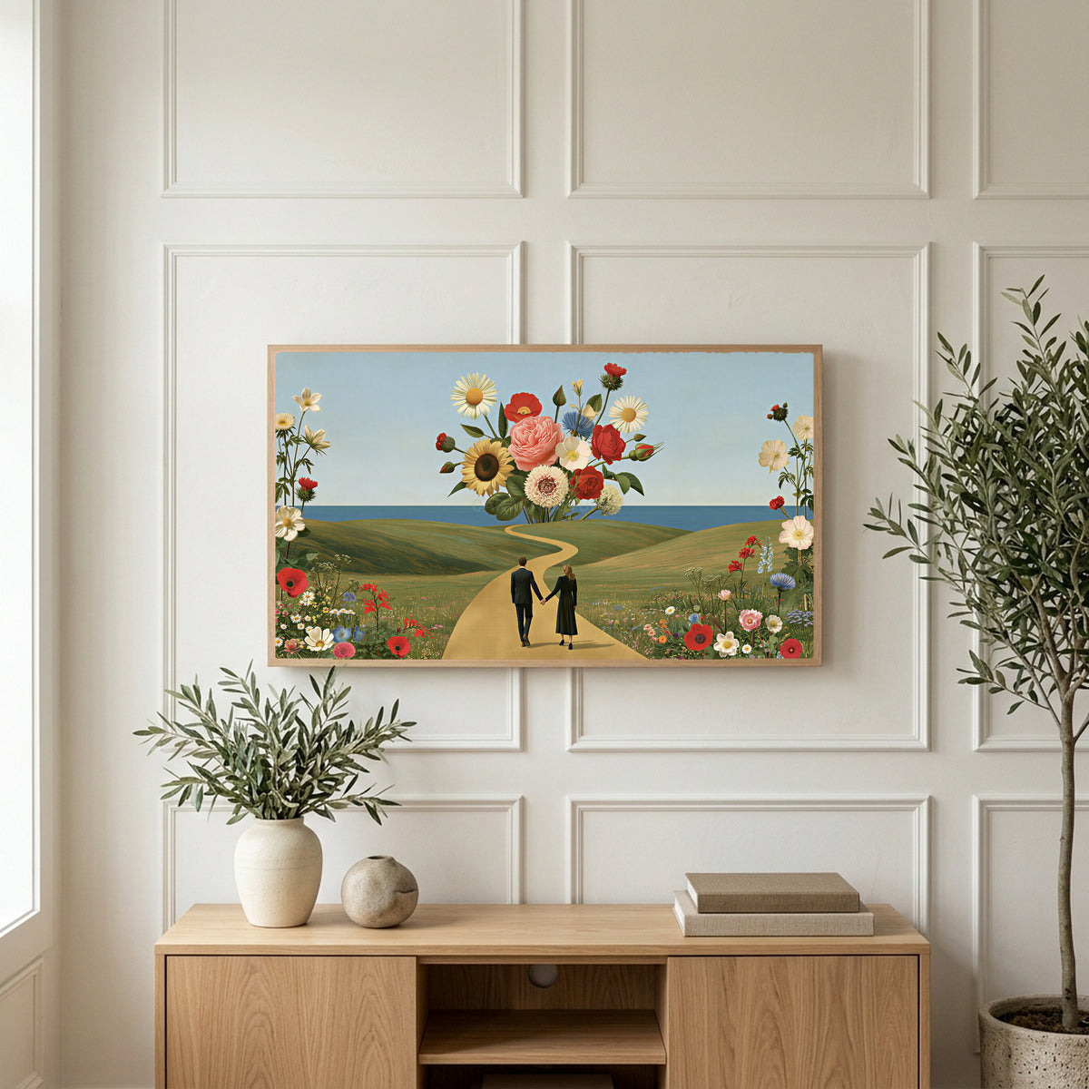 Flower collage art on a TV above a light oak sideboard with olive branches in a bright living room