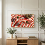 Martini cocktails art on a TV above a light oak sideboard with olive branches in a bright living room