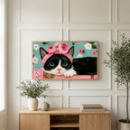 Cat with a flower crown art on a TV above a light oak sideboard with olive branches in a bright living room