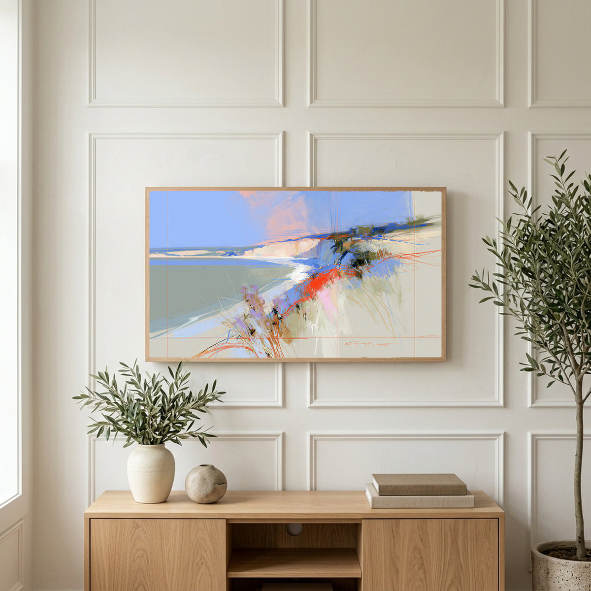 Abstract chalk cliffs art on a TV above a light oak sideboard with olive branches in a bright living room