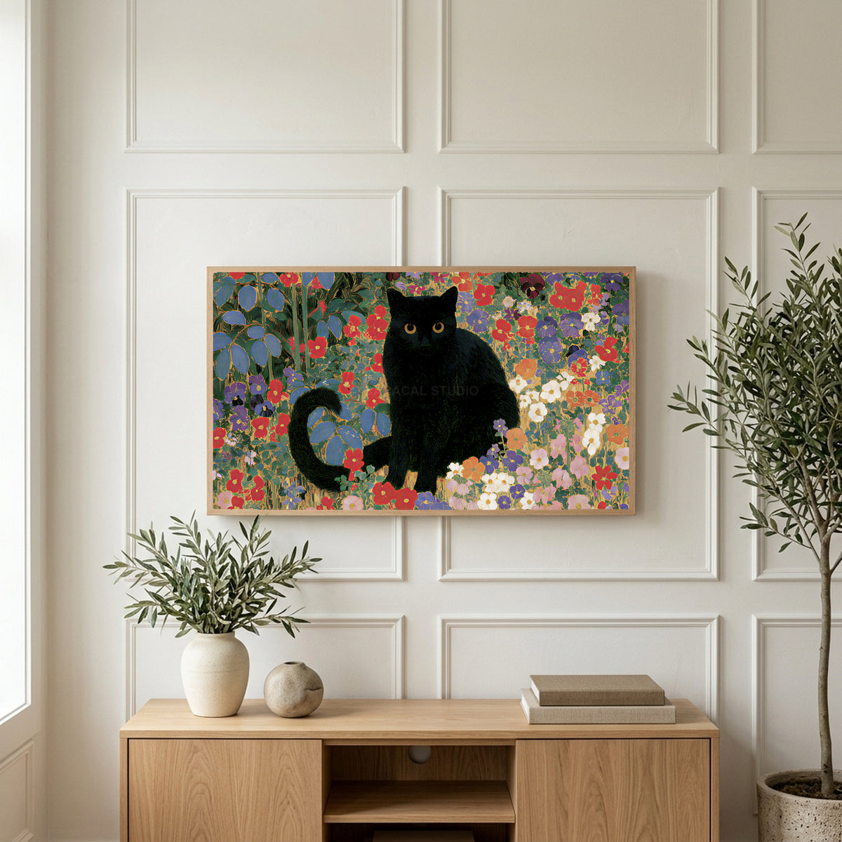 Black cat garden art on a TV above a light oak sideboard with olive branches in a bright living room
