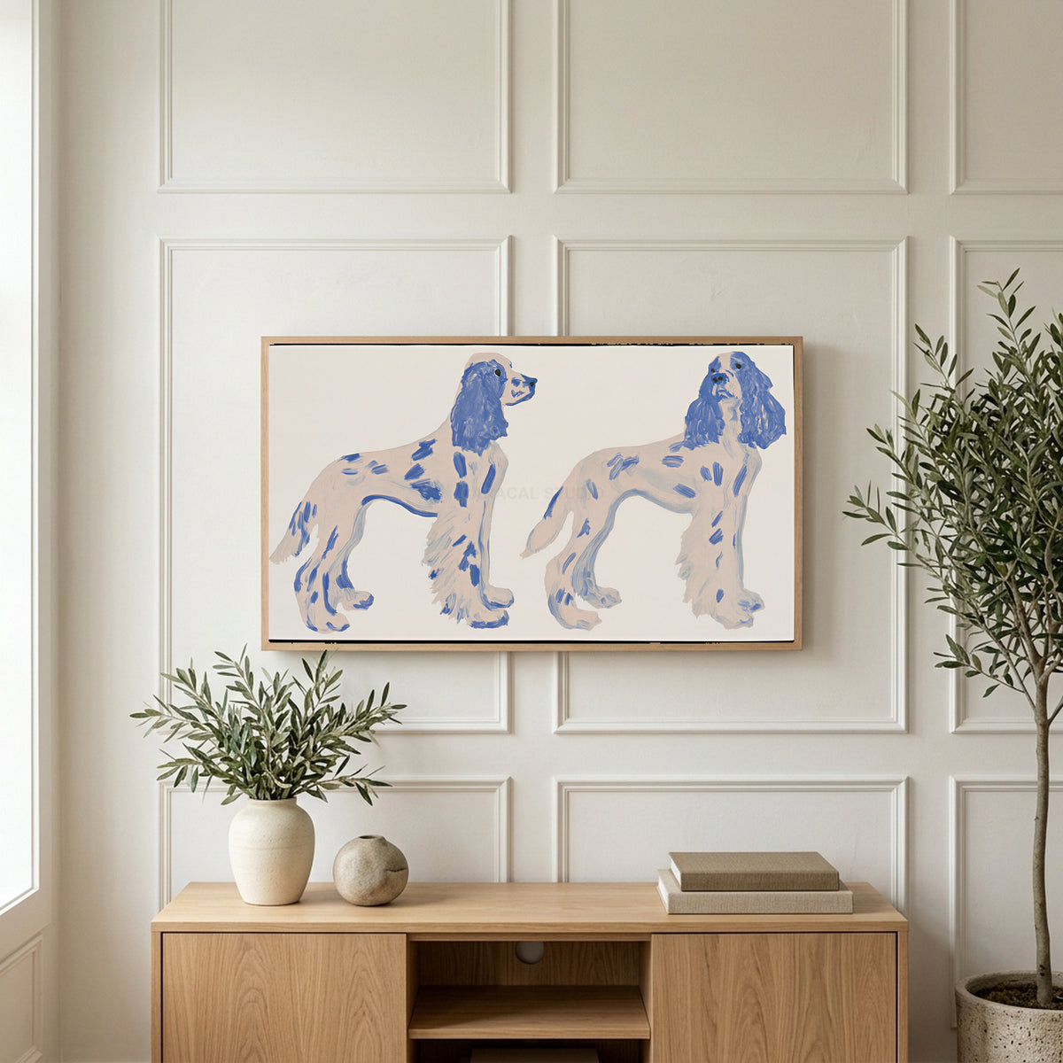 Spaniel figurines art on a TV above a light oak sideboard with olive branches in a bright living room