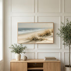 Dune grass and daisies art on a TV above a light oak sideboard with olive branches in a bright living room