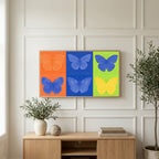 Pop art butterfly art on a TV above a light oak sideboard with olive branches in a bright living room