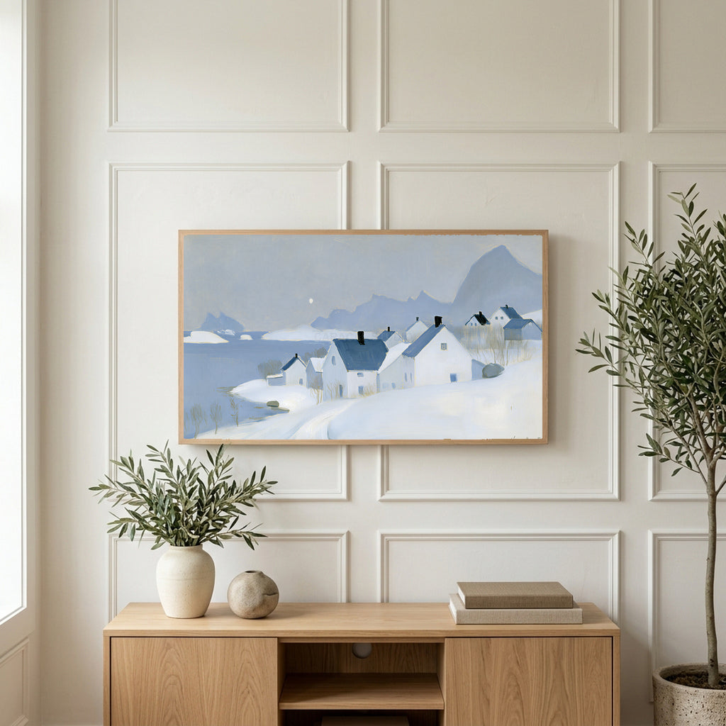 Snowy seaside village art on a TV above a light oak sideboard with olive branches in a bright living room