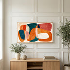 Organic shapes art on a TV above a light oak sideboard with olive branches in a bright living room