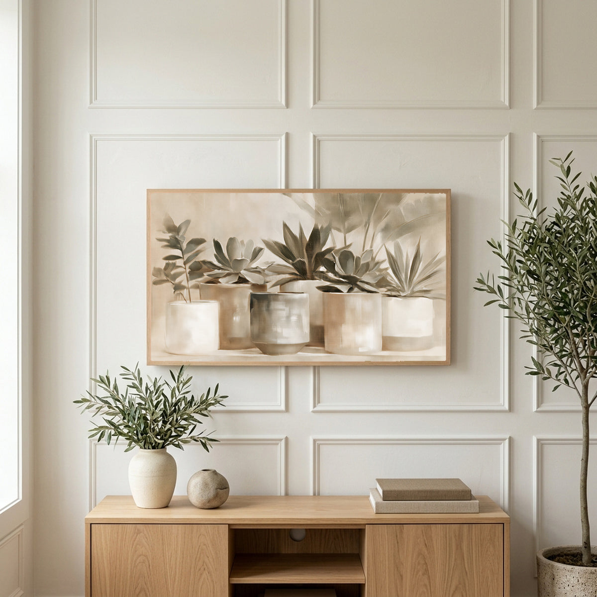 Neutral succulent pots art on a TV above a light oak sideboard with olive branches in a bright living room