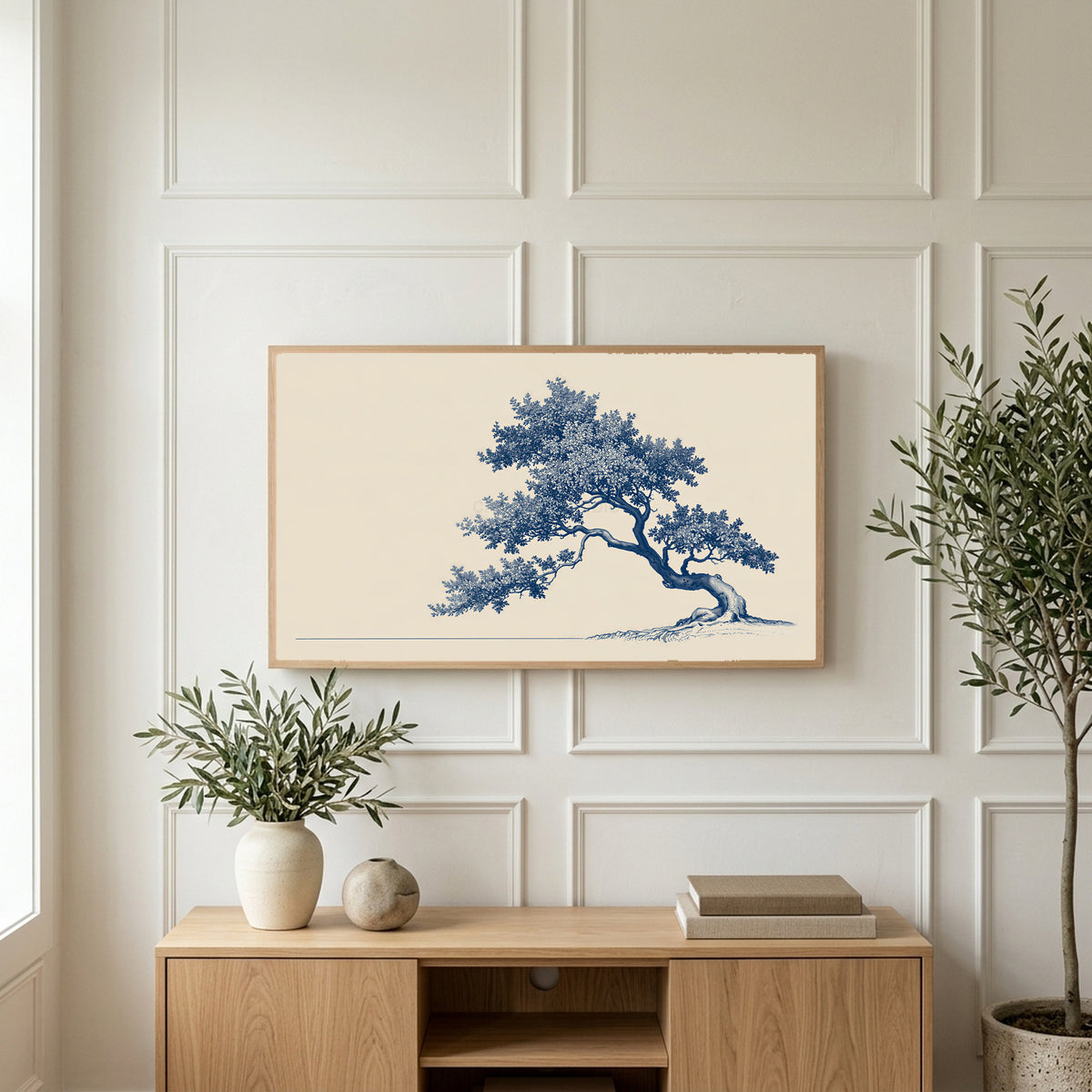 Blue ink tree art on a TV above a light oak sideboard with olive branches in a bright living room