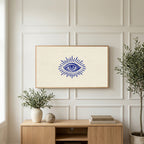 Mystic eye art on a TV above a light oak sideboard with olive branches in a bright living room