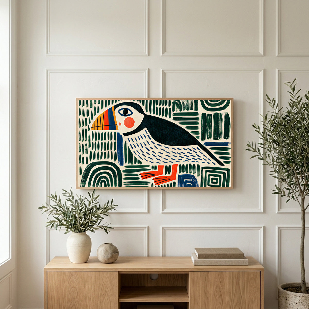 Folk art puffin art on a TV above a light oak sideboard with olive branches in a bright living room