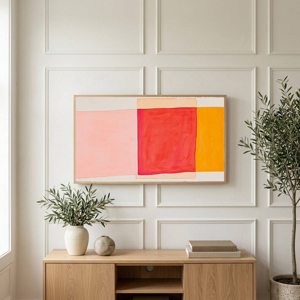 Abstract color blocks art on a TV above a light oak sideboard with olive branches in a bright living room