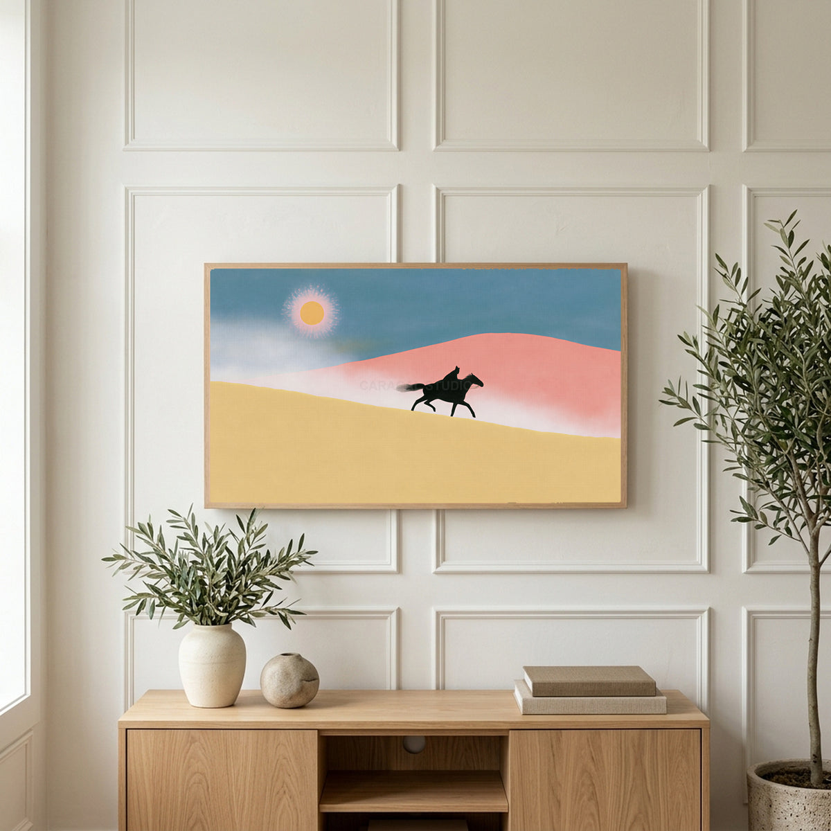 Rider in the desert art on a TV above a light oak sideboard with olive branches in a bright living room