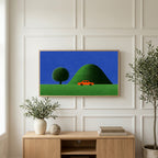 Red car by a green hill art on a TV above a light oak sideboard with olive branches in a bright living room