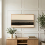 Ink wash horizon art on a TV above a light oak sideboard with olive branches in a bright living room