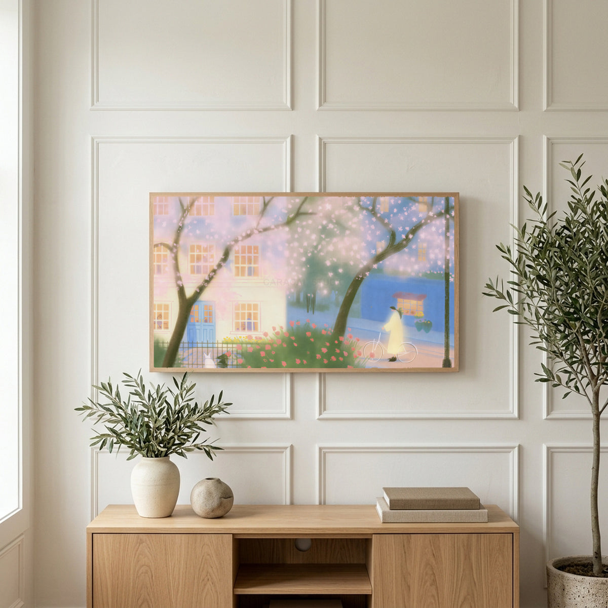 Cherry blossom street art on a TV above a light oak sideboard with olive branches in a bright living room