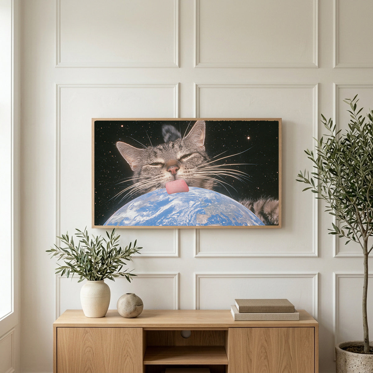 Space cat art on a TV above a light oak sideboard with olive branches in a bright living room